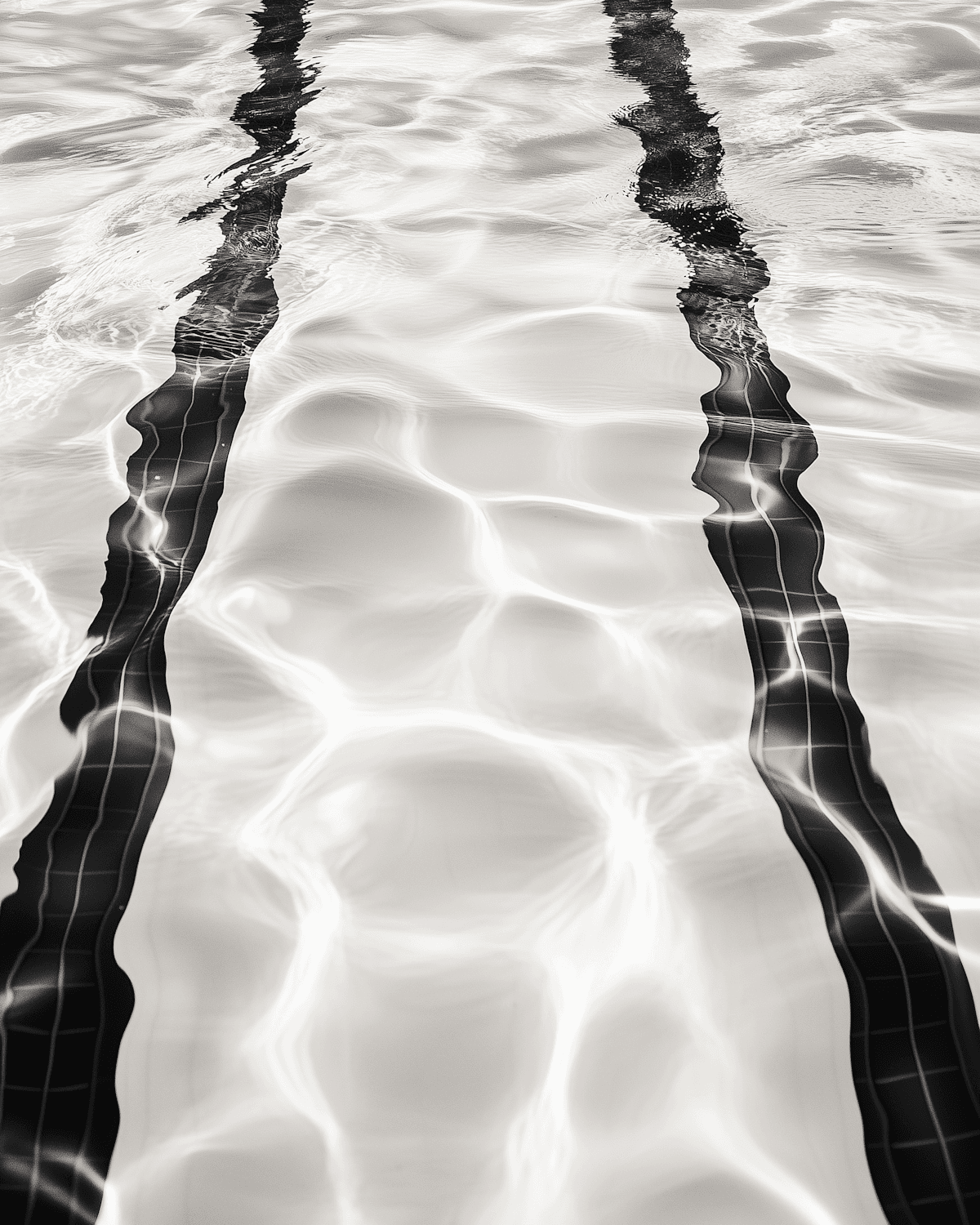 Light rippling across the lane lines of a pool